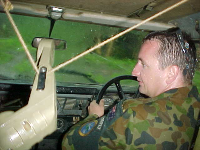 SGT Adam Moss navigating his Land Rover 110 during a monsoonal down pour.